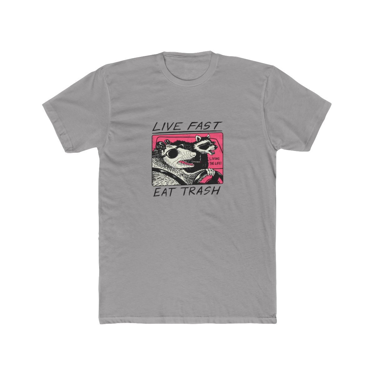 White T Shirt featuring a graphic of two animals driving a car. The text "Live Fast Eat Trash" is printed on the shirt. The animals are a raccoon and a possum. The raccoon is wearing sunglasses and...